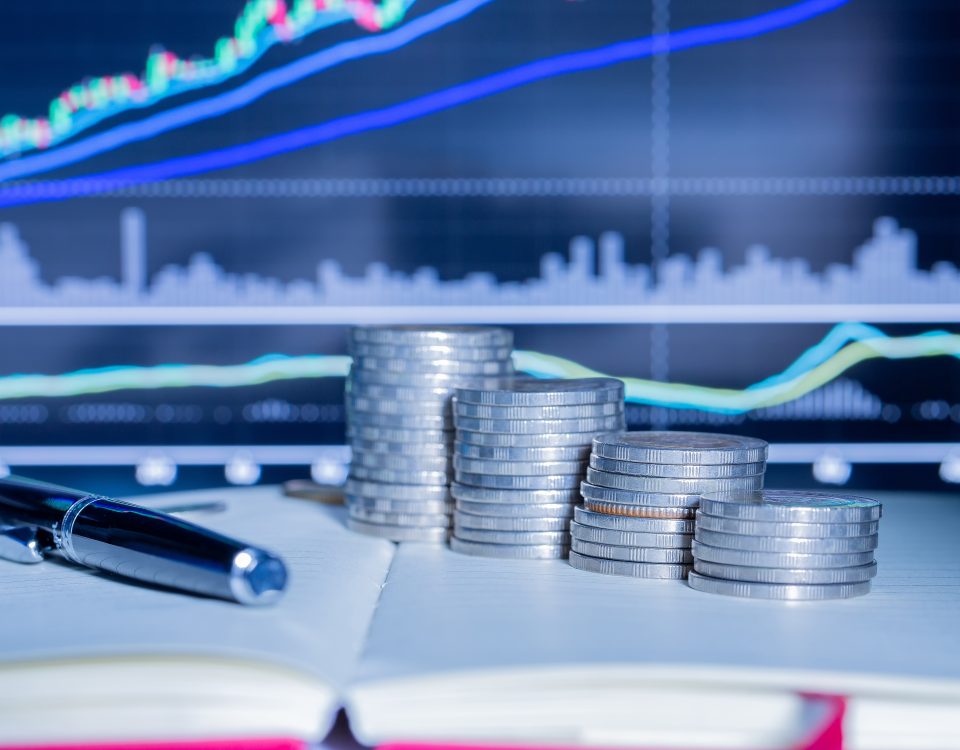 Stack of money coin with trading graph.